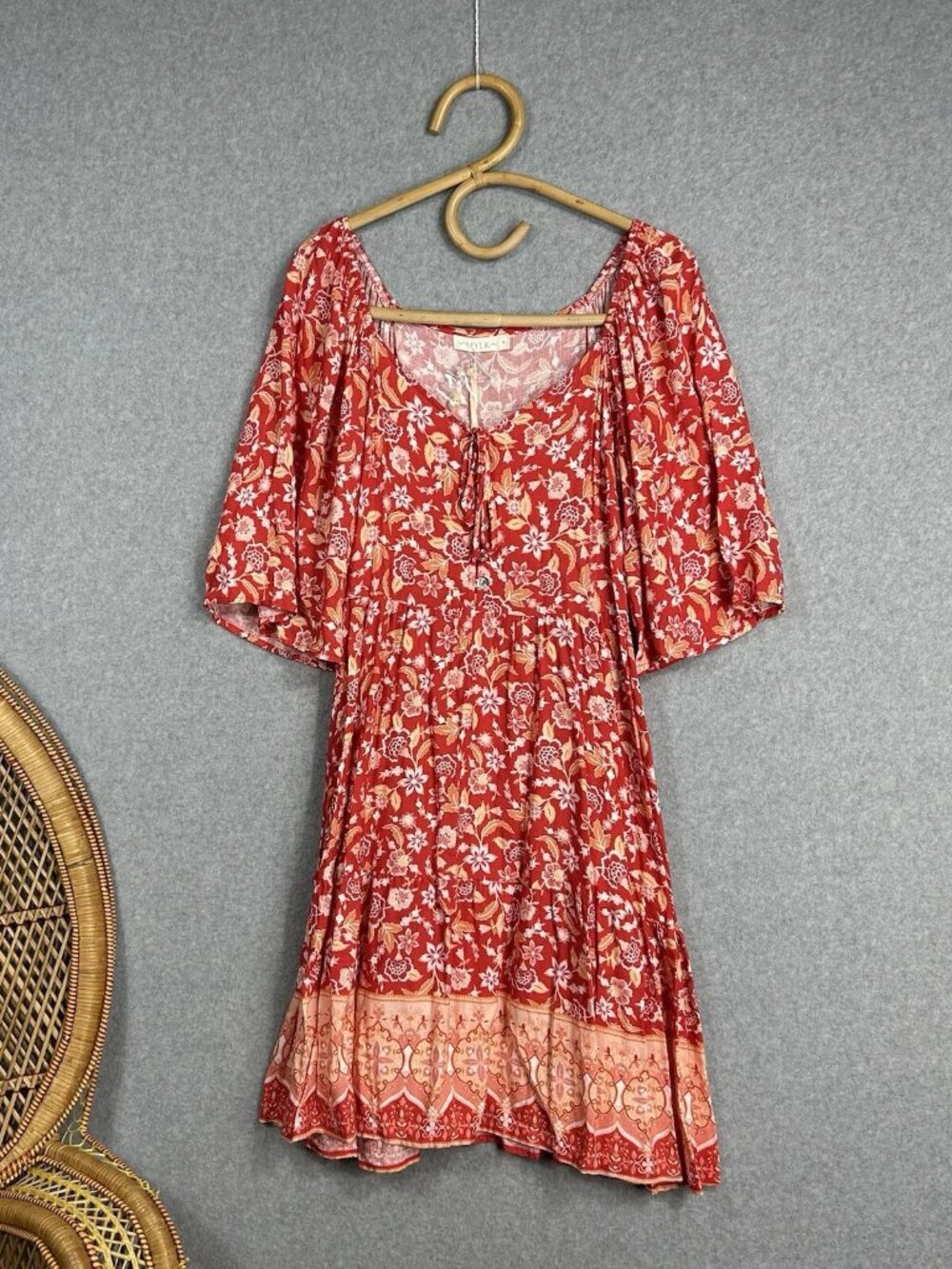 Red-orange flowers decorating the skirt in size 8